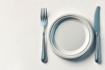 Plate with fork and knife on a light background. Space for textの素材