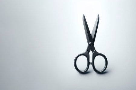 Black scissors on a light background. Space for textの素材