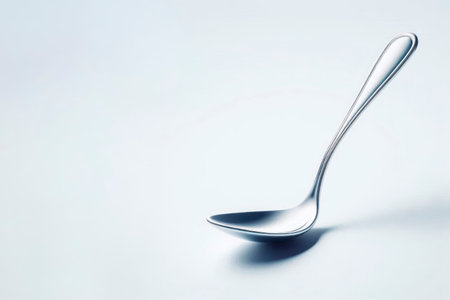 An elegant metal spoon ladle on a light background. Space for textの素材