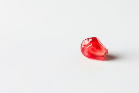 Pomegranate seed on a white background. Space for textの素材