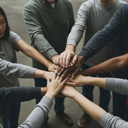 The hands of different people are joined in a symbol of unity and supportの素材