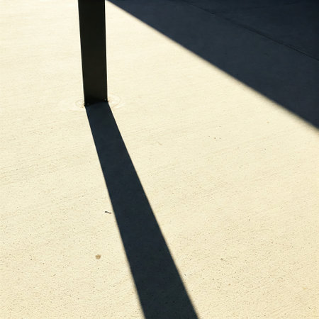 The shadow of a pole on the sunny asphaltの素材