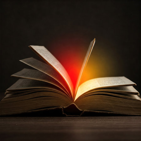 An open book with a glow of light between the pages in the darkの素材