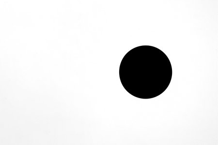 Black circle on a white background. Space for textの素材