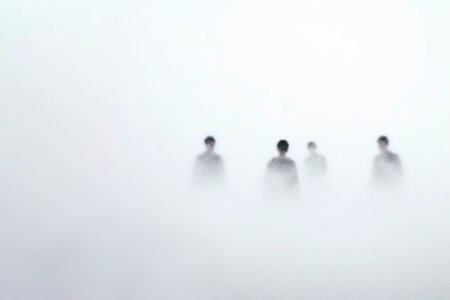Silhouettes of people lost in the white mist. Space for textの素材