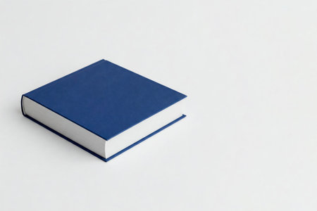 A blue book on a light background. Space for textの素材