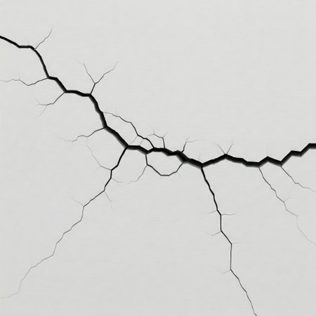 Cracks on the white surface, symbolizing destruction and vulnerabilityの素材
