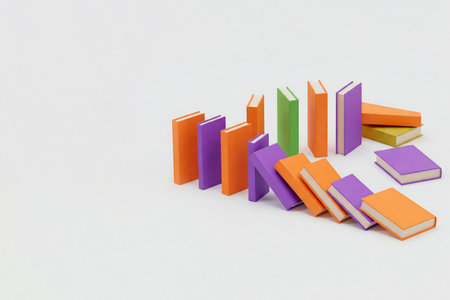 Books of different colors stand and fall like a domino. Space for textの素材