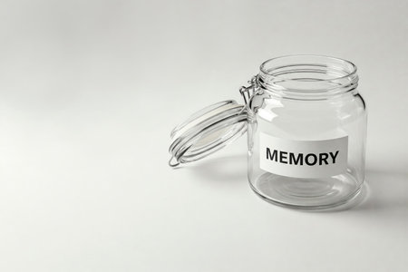 A transparent jar with the inscription MEMORY on a light background. Space for textの素材