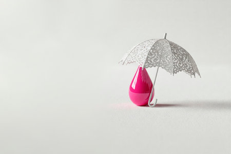 A pink drop under a white lace umbrella. Space for textの素材
