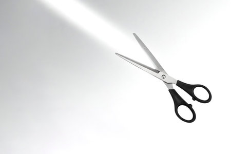 Scissors cutting a light beam. Space for textの素材