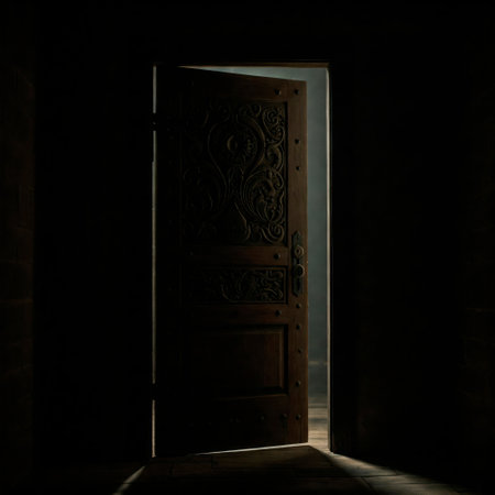 An old wooden door in the dark with a glimmer of lightの素材