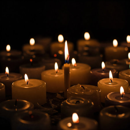 One lit long candle among many other burning candlesの素材