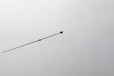 A thin black arrow on a white textured surface. Space for textの素材