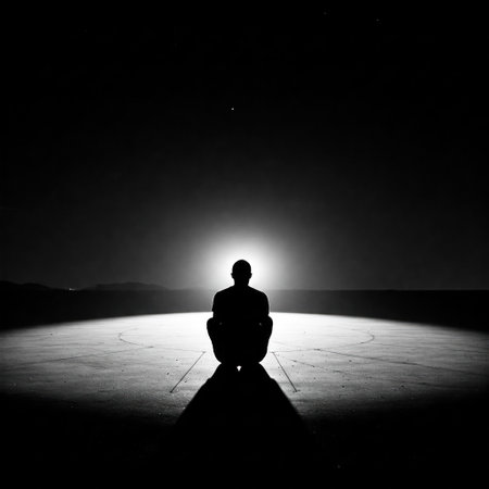 A man sits alone in the light in the darknessの素材