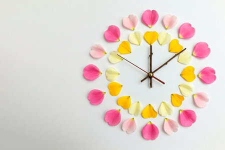 Flower petals and branches form a clock. Space for textの素材