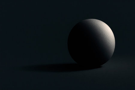 A dark ball in minimalist lighting. Space for textの素材