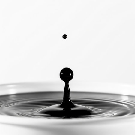 A drop of black liquid falls into the water. Space for textの素材