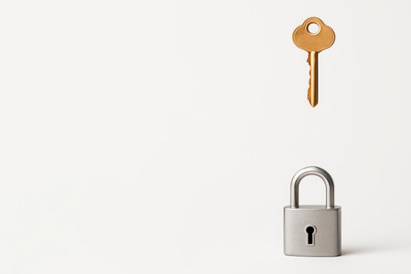 A key hanging above a lock on a light background. Space for textの素材