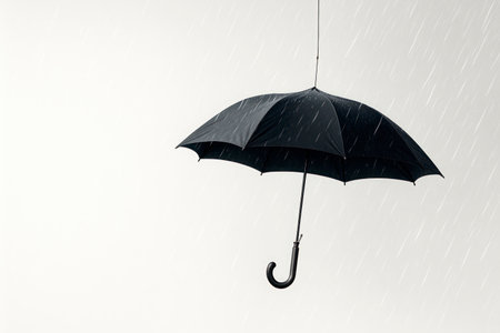 A lonely umbrella hangs in the rainy air. Space for textの素材