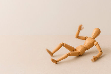 Falling wooden mannequin in dynamic motion. Space for textの素材