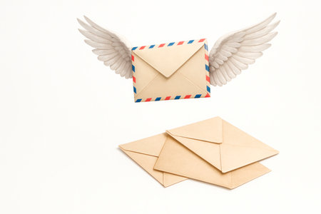 A letter with wings soars up from the rest of the envelopesの素材