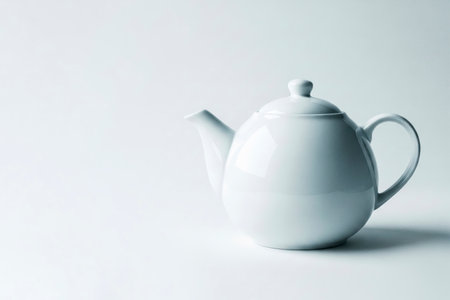 A white kettle on a clean background in a studio light. Space for textの素材