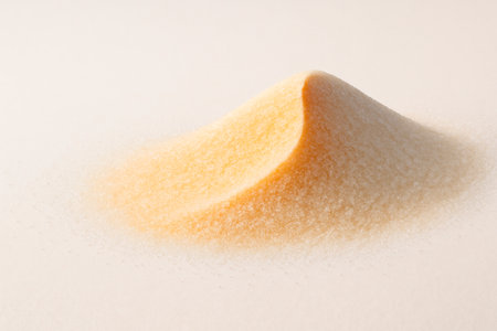 A pile of yellow sand in the shape of a pyramid. Space for textの素材