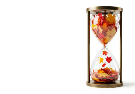 An hourglass filled with autumn leaves. Space for textの素材