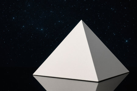 A white pyramid against the background of the night starry sky. Space for textの素材