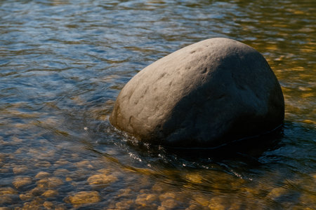 Stone in clear river water. Space for textの素材