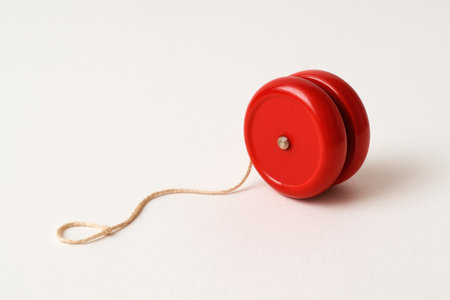 A yo-yo lying on the floor with a rope. Space for textの素材