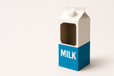 An empty cardboard milk carton with a cutout. Space for textの素材