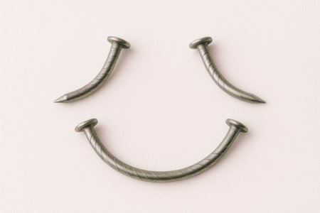 Nails bent in the shape of a smiling faceの素材