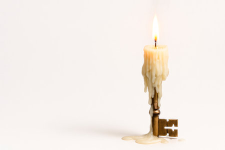 A candle in the shape of an antique key. Space for textの素材
