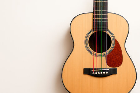 Guitar with multi-colored strings on a light background. Space for textの素材