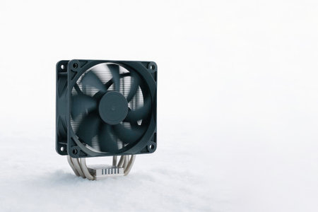 Computer CPU cooler with heatsink and fan in the snow. Space for textの素材