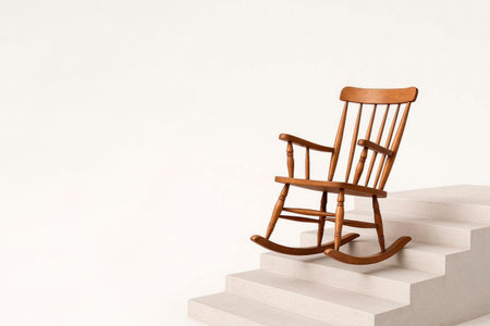 Wooden rocking chair on light steps. Space for textの素材