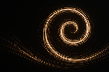 A light spiral on a dark background in motion. Space for textの素材