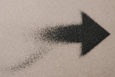 A black arrow made of granules scattered in spaceの素材