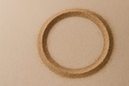 A circle of sand on a beige background. Space for textの素材