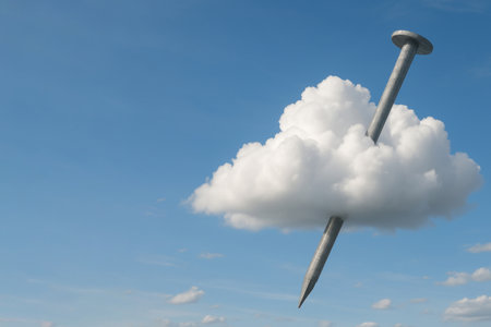 A giant nail piercing a white cloud in the blue skyの素材