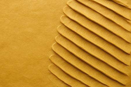 Yellow clay texture with diagonal stripes. Space for textの素材