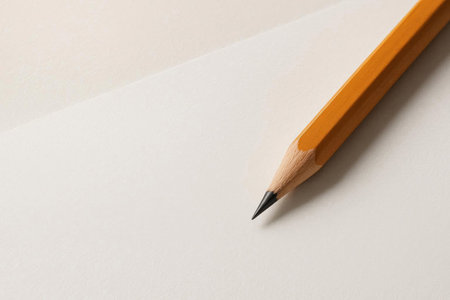 A yellow pencil on a light background, a tool for creativity. Space for textの素材