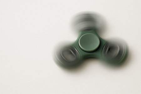 Rotating green spinner on a light background. Space for textの素材