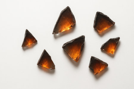 Shards of amber glass on a light backgroundの素材