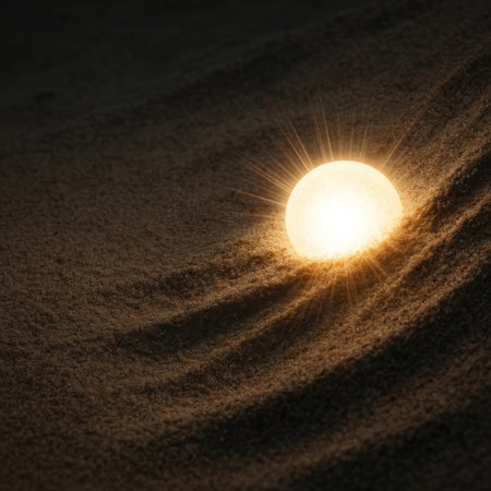A glowing hemisphere lying in the sand at nightの素材