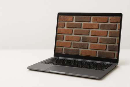 A laptop with a brick wall on the screen as a lock symbol. Space for textの素材