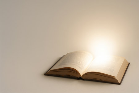 An open book with a soft, glowing glow. Space for textの素材