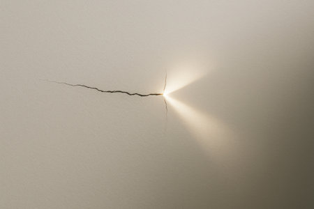 A crack in the wall from which light bursts out. Space for textの素材